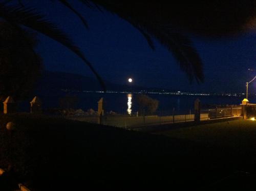 a view of the ocean at night at Chris Studios & Apartments in Lechaio