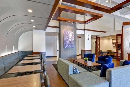 a lobby of a hospital with blue chairs and tables at Hyatt Place Memphis Wolfchase in Memphis
