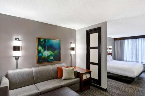 a hotel room with a couch and a bed at Hyatt Place Birmingham/Hoover in Hoover