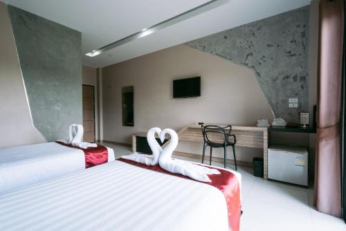 Postel nebo postele na pokoji v ubytování Ray Hotel Buriram