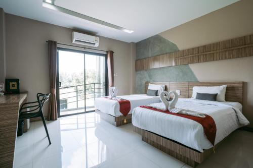 Postel nebo postele na pokoji v ubytování Ray Hotel Buriram