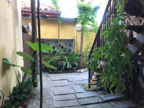 a garden with a stone walkway and a fence at Spices Hotel in George Town