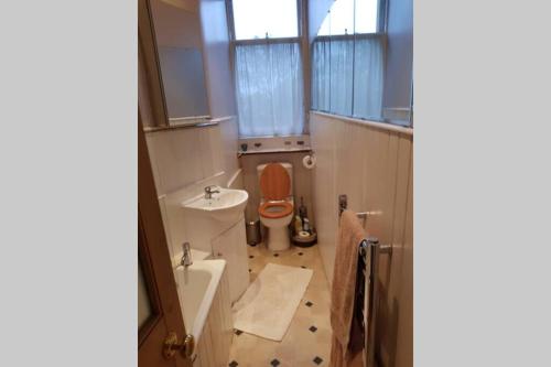 a small bathroom with a toilet and a sink at Woodburn Terrace, Morningside, Edinburgh in Edinburgh