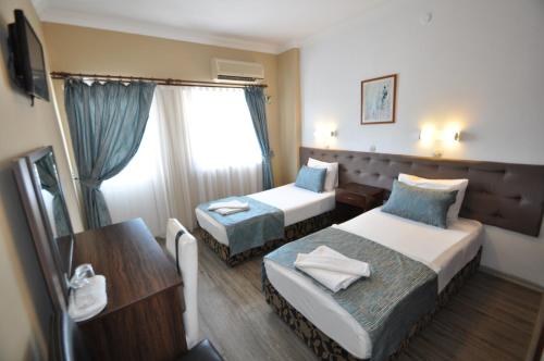 Säng eller sängar i ett rum på Reis Maris Hotel