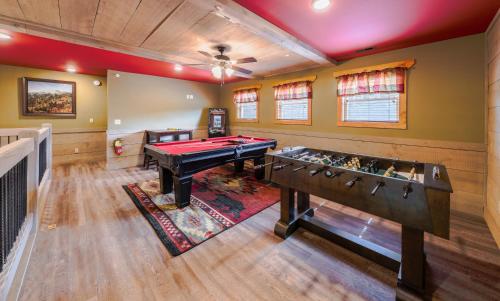 a game room with a pool table and foosball at Lap of Luxury chalet in Gatlinburg