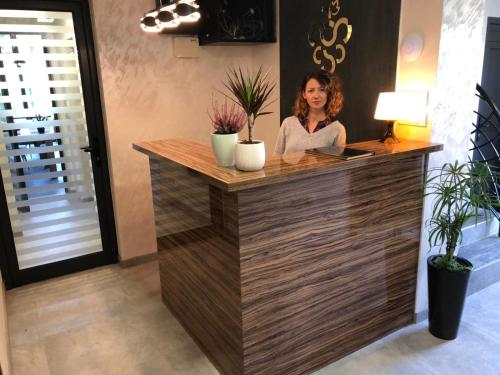 a woman sitting at a counter in a room at Luxury Apartments 88 in Smederevo