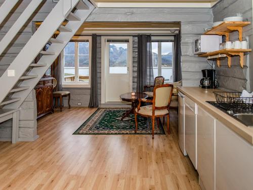 a kitchen with a table and a dining room at Sandvika Camping in Kabelvåg