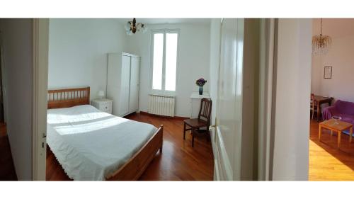 a bedroom with a bed and a table and chairs at Casa Dalia in Pietrabruna