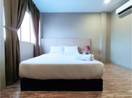 Postel nebo postele na pokoji v ubytování Princess Hotel Pontian