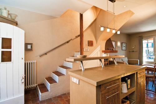 a kitchen with a spiral staircase in a house at Maison de pêcheur in Grimaud