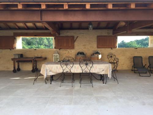 a room with a table and chairs in a building at La Tour de Ginaillac in Les Arques