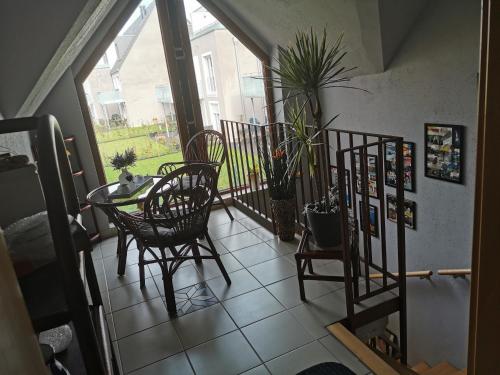 a balcony with a table and chairs and a window at R&A Lambertz in Düsseldorf