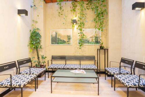 
a room with a table, chairs, and tables in it at Hotel Boutique Puerta de las Granadas in Granada
