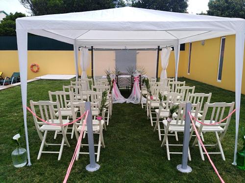 a group of white chairs under a white tent at Quinta Salinas - Puro Prazer in Aveiro