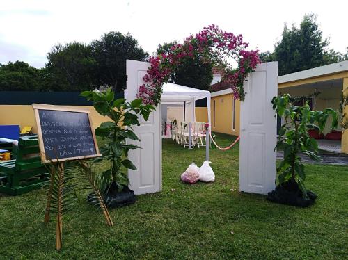 a garden with a chalk board and some flowers at Quinta Salinas - Puro Prazer in Aveiro