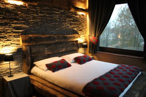 a bedroom with a bed with two pillows on it at Locanda Cà Del Pian in Villanova Mondovì