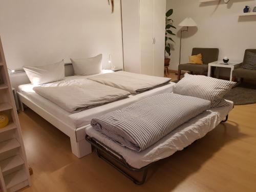 a bed with two pillows on it in a room at Studio NICO Dominsel in Brandenburg an der Havel
