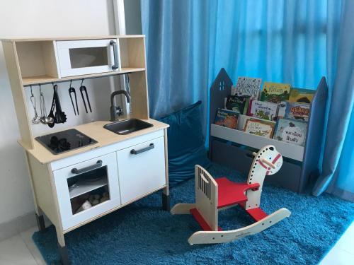 a toy kitchen with a sink and a table at My Resort Family Condo Huahin in Hua Hin