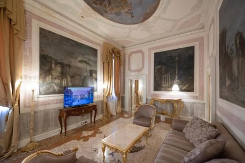 a living room with a couch and a tv at Ca' Bonfadini Historic Experience in Venice