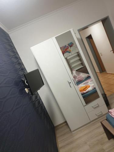 a room with an open door to a refrigerator at Sunnesching 2 in Sankt Michaelisdonn