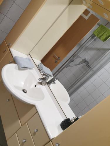 a white sink in a bathroom with a mirror at Sunnesching 2 in Sankt Michaelisdonn