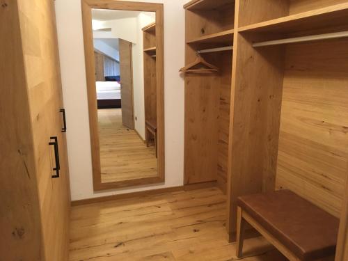 a room with wooden floors and a mirror at Hotel Tyrolis in Zirl