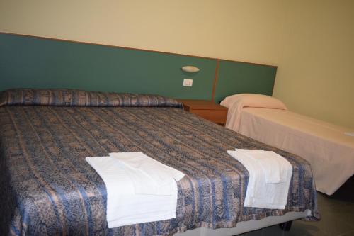 a hotel room with a bed with towels on it at Hotel River in Civitella Roveto