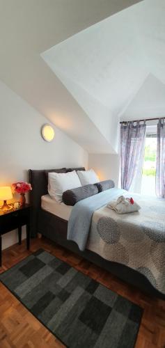 a bedroom with a bed and a window at Apartments Villa Bare in Kastav