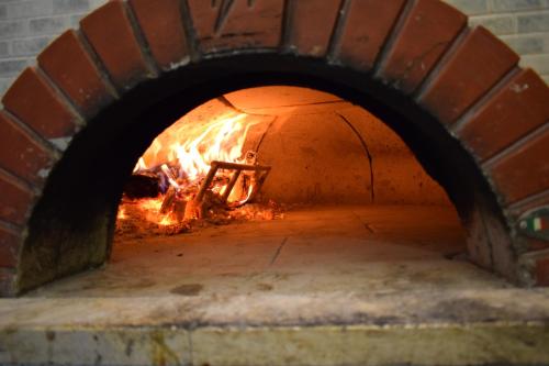 a brick oven with a fire in it at Hotel River in Civitella Roveto