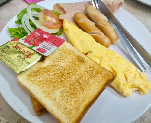 a plate of food with toast and eggs and vegetables at The Krabi Forest Homestay in Ao Nang Beach