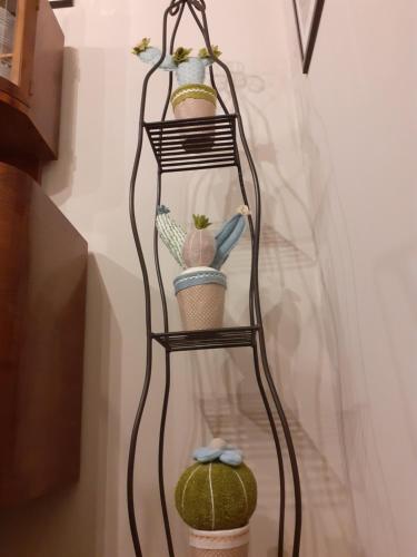 a shelf with three pots and a watermelon on it at B&B La Fenice sul Lago in Villongo SantʼAlessandro