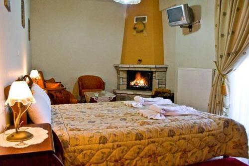 a bedroom with a bed and a fire place at Hotel Orama in Kryonérion
