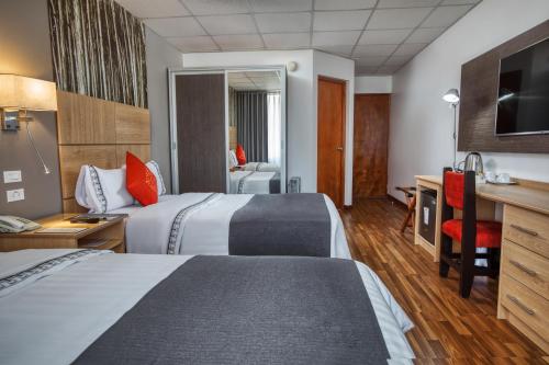 En eller flere senge i et værelse på Xima Exclusive Puno