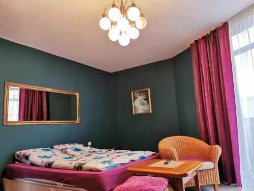 a bedroom with a bed and a table and a chair at Sasso-апартамент 4, Sasso-студио 5 in Pleven