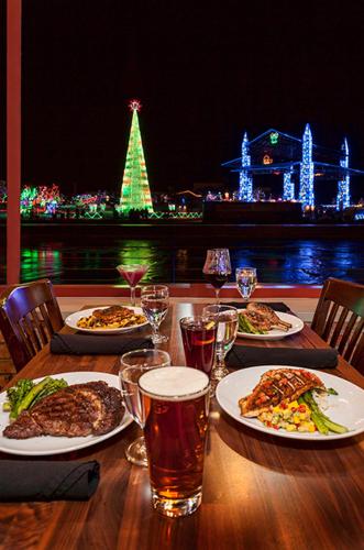 a table with plates of food and glasses of beer at Pier B Resort in Duluth