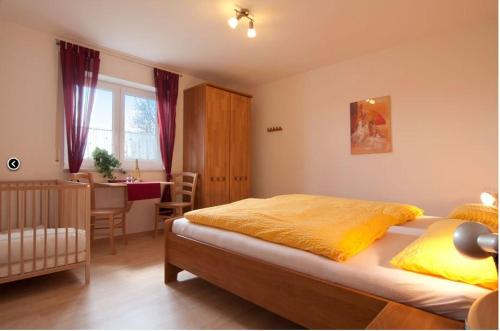 a bedroom with a bed and a dining room with a table at Ferienhof Musch GbR in Rot an der Rot