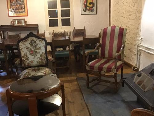 a room with chairs and a table with a piano at Mas Graffouil in Prats-de-Mollo-la-Preste