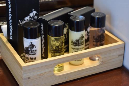 a wooden box with four bottles of alcohol at Bahus Inn in Belgrade