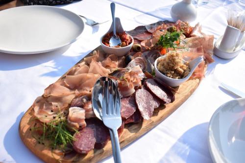 a plate of food on a table with meat and dips at Bahus Inn in Belgrade