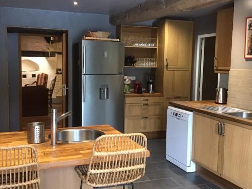 a kitchen with a sink and a refrigerator at Mas Graffouil in Prats-de-Mollo-la-Preste