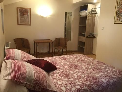 a bedroom with a bed and a table and chairs at Mas Graffouil in Prats-de-Mollo-la-Preste