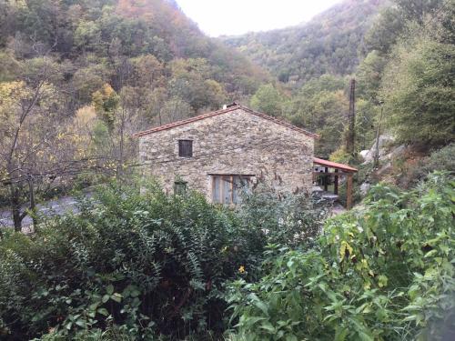 a stone house in the middle of a mountain at Mas Graffouil in Prats-de-Mollo-la-Preste