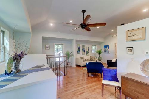 a dining room and living room with a ceiling fan at The Cottage at DuPont in Charleston