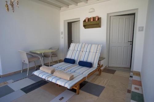 a living room with a chair and a table at Cyclades Studios in Parikia
