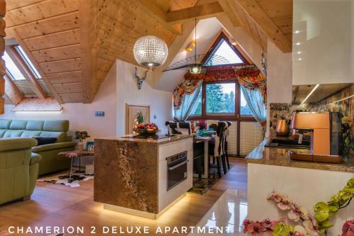 a kitchen and living room in a log cabin at Polana Szymoszkowa Ski Resort - Chamerion Apartments in Zakopane