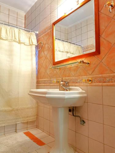 a bathroom with a sink and a mirror at Villa Ευορέων in Pertouli