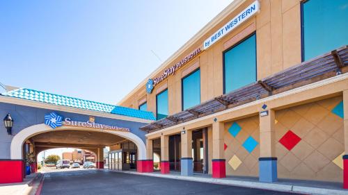 a building with an entrance to a parking garage at SureStay Plus Hotel by Best Western Lubbock Medical Center in Lubbock