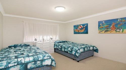 a bedroom with two beds and a window at Kingscliff Waters Apartment 5 in Kingscliff