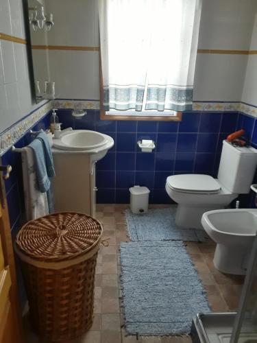 a bathroom with a toilet and a sink at Casa da Matilde in Fajã de São João