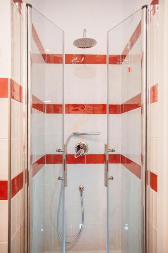 a shower with a glass door in a bathroom at Be Your Home - Guest House Colors in Civitavecchia